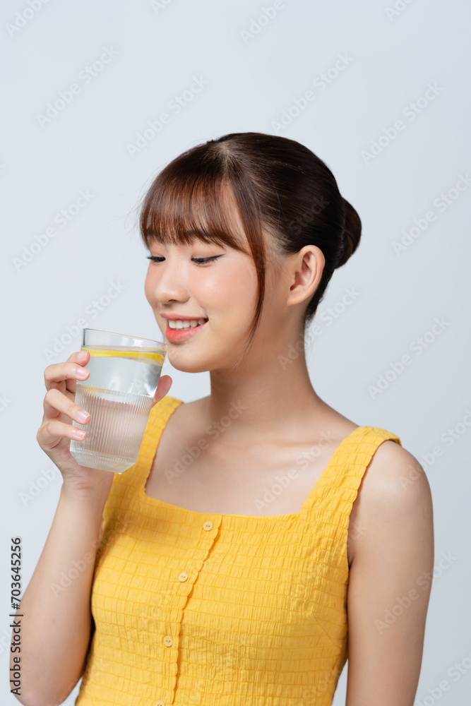 Young woman hold water glass and lemon isolated on white background Young woman hold water glass and lemon isolated on white background