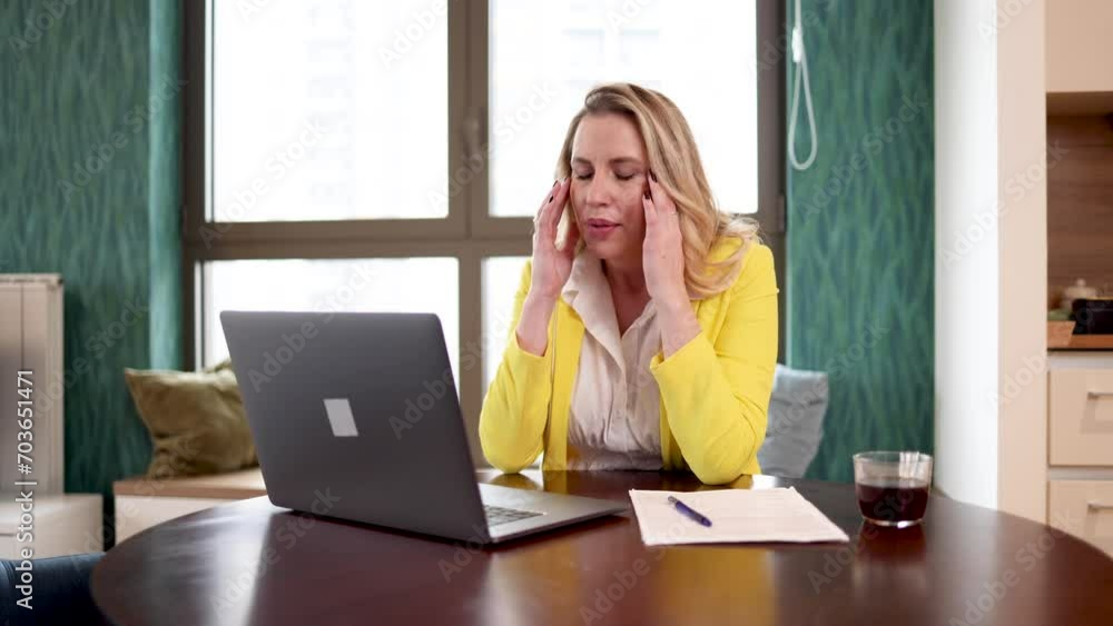 Woman having a headache while working Woman having a headache while working