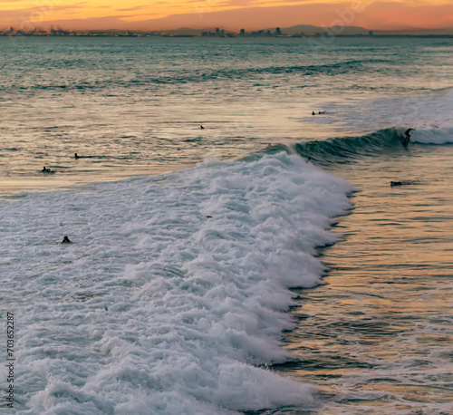 Distant View of Surfers in Whitewater Against Distant Sunset  Huntington Beach  California  USA  square