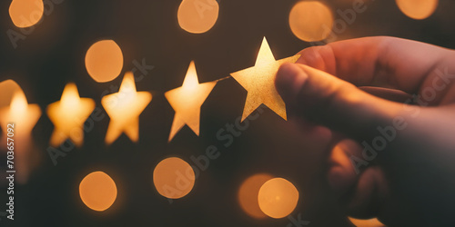 A hand placing a gold star. Customer satisfaction concept. Reviewing a business. 5 stars. photo