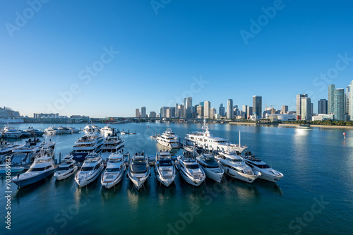 Yachts docked at Yacht Haven Grande marina on Jungle Island with City of Miami, Florida in background.