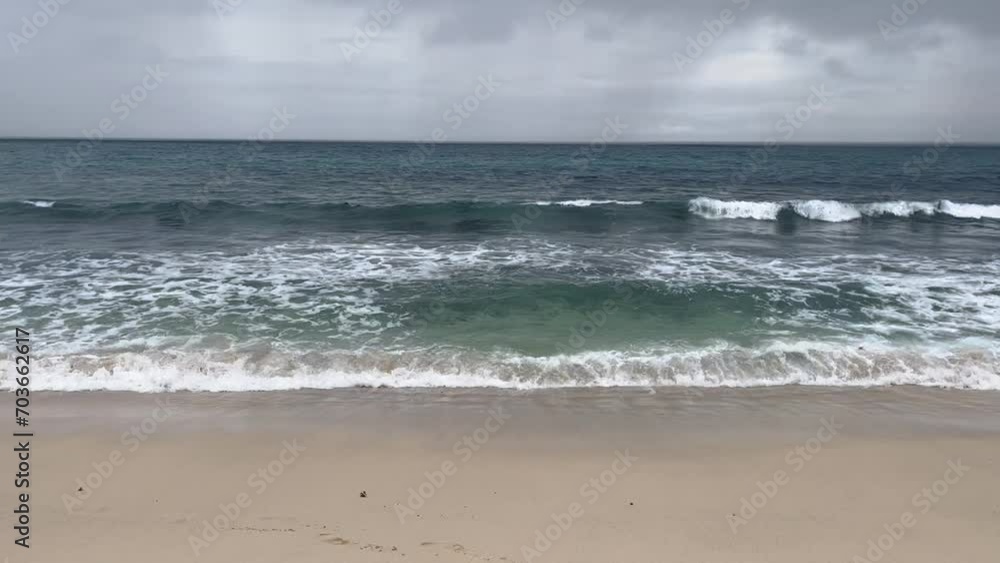 Idyllic view of waves splashing on seashore at beach. Beautiful seascape against cloudy sky. Concept of scenic nature. Idyllic view of waves splashing on seashore at beach. Beautiful seascape against cloudy sky. Concept of scenic nature.