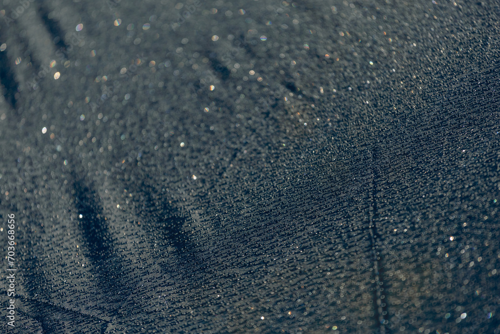 Drops of water on a dark matte surface close up. Drops of water on a dark matte surface close up.