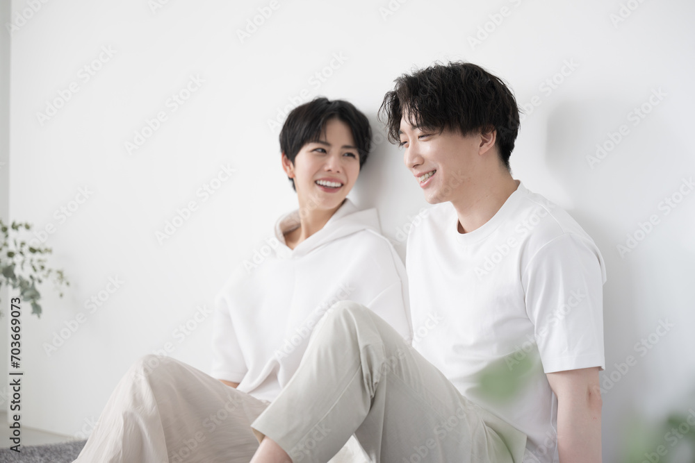 Couple relaxing in their room wearing relaxing clothes Couple relaxing in their room wearing relaxing clothes