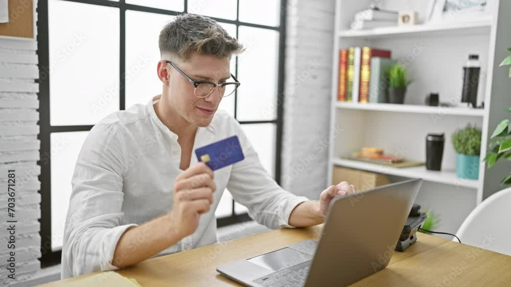 Handsome young caucasian man celebrating success, shopping online with laptop and credit card at office workplace Handsome young caucasian man celebrating success, shopping online with laptop and credit card at office workplace