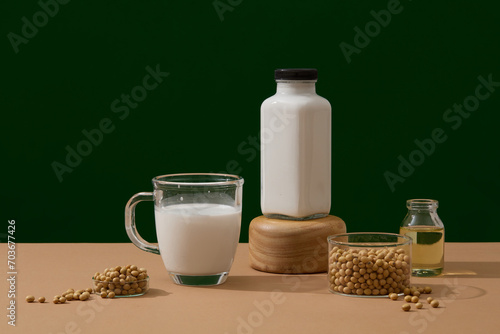 Healthy concept with soybean milk and soybean oil filled inside a glass and bottles. A bowl of soybeans featured. Soy extract can help to even out skin tone and brighten the skin
