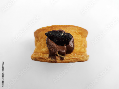 Cromboloni, New York Roll Croissant with chocolate sauce topping, isolated white background. photo