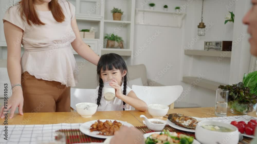 Asian family, daughter drinking milk at breakfast time
Asian family, daughter drinking milk at breakfast time