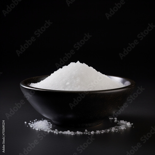salt on black bowl on white background