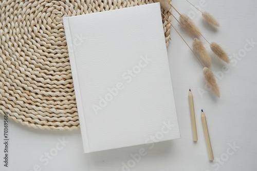 White hard cover book mockup for notebook, work book, calendar, planner or journal design presentation, bohemian style flat lay composition for social media or online shop.