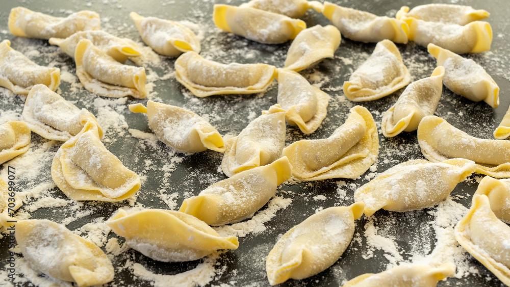 A kind of ravioli, casoncelli, home made traditional food of the Bergamo area, Italy. Delicious Italian food. Black background A kind of ravioli, casoncelli, home made traditional food of the Bergamo area, Italy. Delicious Italian food. Black background