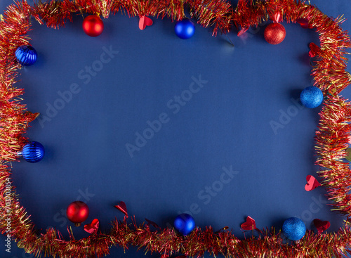 Blue Christmas background with colorful balls and red ribbon