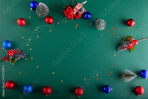 Green Christmas background with colorful balls, stars and twigs