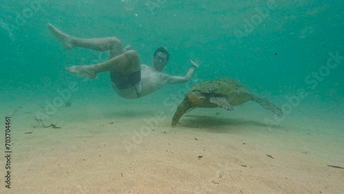 young man with wild turtle in Sri Lanka