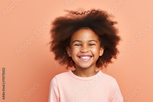 Smiling black girl boy studio portrait, simple background. AI generative © tiena