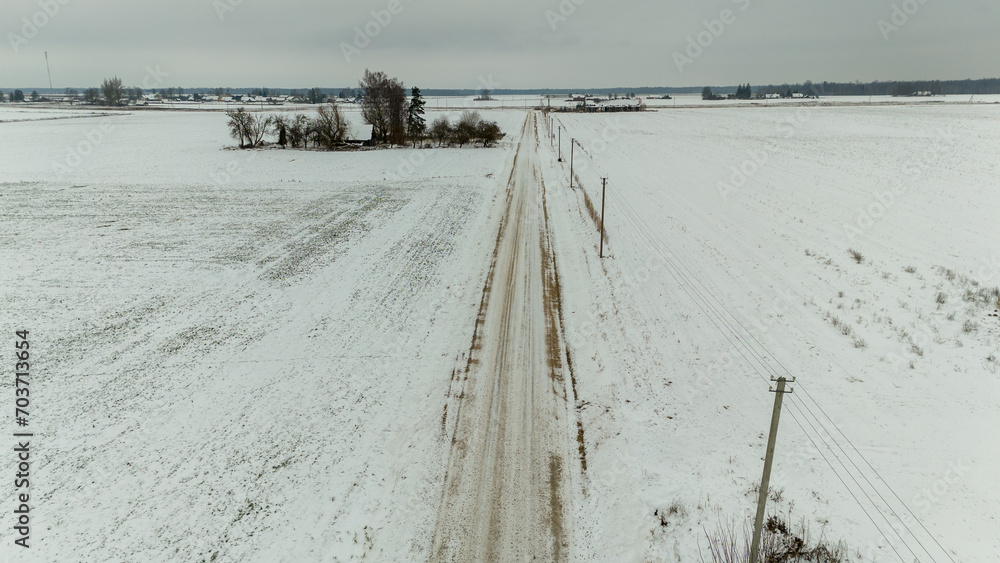Drone photography of small rural dirt road during winter day Drone photography of small rural dirt road during winter day