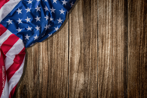 Top view overhead America United States flag, memorial remembrance and thank you of hero, studio shot with copy space on wooden table background, USA holiday Veterans or Independence day concept.