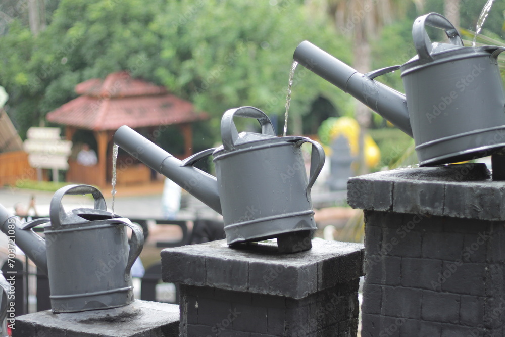 Plant watering cans are placed in a row like steps Plant watering cans are placed in a row like steps