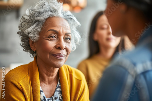 Portrait of a joyful senior African American woman smiling warmly during a conversation, radiating happiness and wisdom.