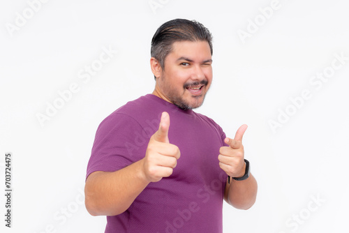 Papier peint An overweight middle aged man winking while making the finger gun gesture