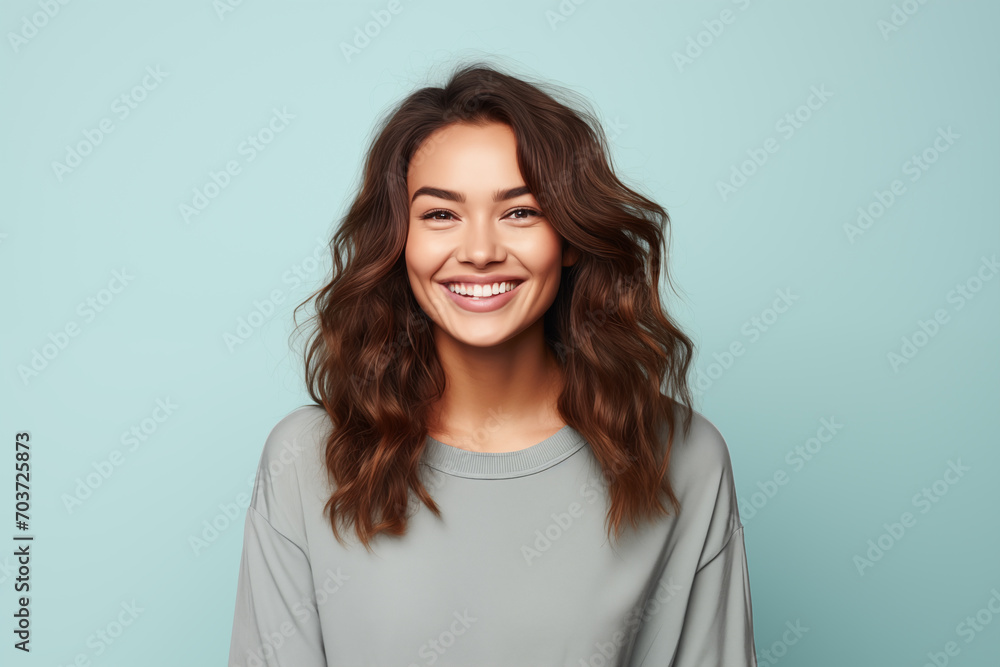Photo of an happy woman wearing casual clothes. Portrait. Isolated on a blue background. Photo of an happy woman wearing casual clothes. Portrait. Isolated on a blue background.
