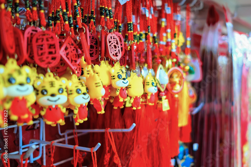 Close up of colourful ornamental decorations for sale in shop before the festive Lunar New Year. Chinese characters 'Fa Cai' on ornament symbolises wealth. Selective focus. Year of the Tiger