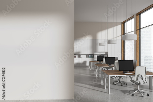 Stylish white office with blank wall