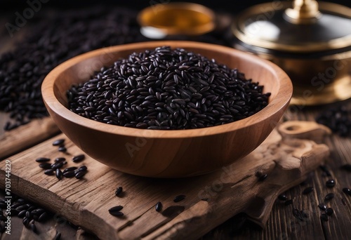 Black rice in wooden bowl on a dark table