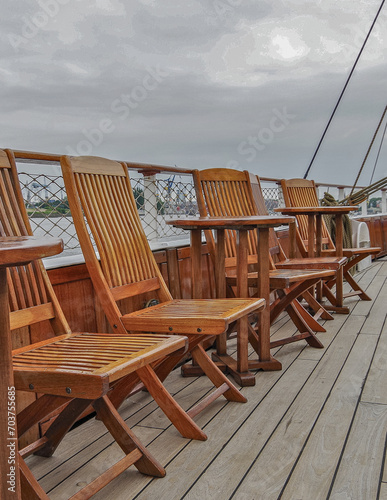 Outdoor promenade and sun decks of nostalgic luxury windjammer sailing yacht cruiseship cruise ship liner with sun loungers and deck chairs on open terrace with superstructure and mast details