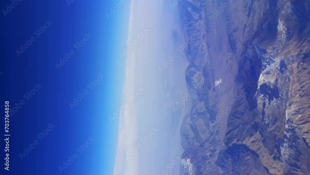 The picturesque view from airplane window over the wing on mountain landscape. High quality 4k footage The picturesque view from airplane window over the wing on mountain landscape. High quality 4k footage