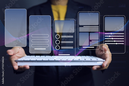 Mobile app user interface design software graphic development concept with graphic designer holding keyboard to UX, UI prototype design and test application in various form to support user requirement photo