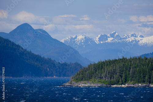 Panoramic morning or day time landscape nature coastal scenery with beautiful blue sky and dramatic cloudscapes in Alaska Inside Passage glacier mountain range view during cruise