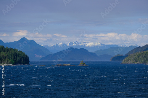 Panoramic morning or day time landscape nature coastal scenery with beautiful blue sky and dramatic cloudscapes in Alaska Inside Passage glacier mountain range view during cruise © Tamme