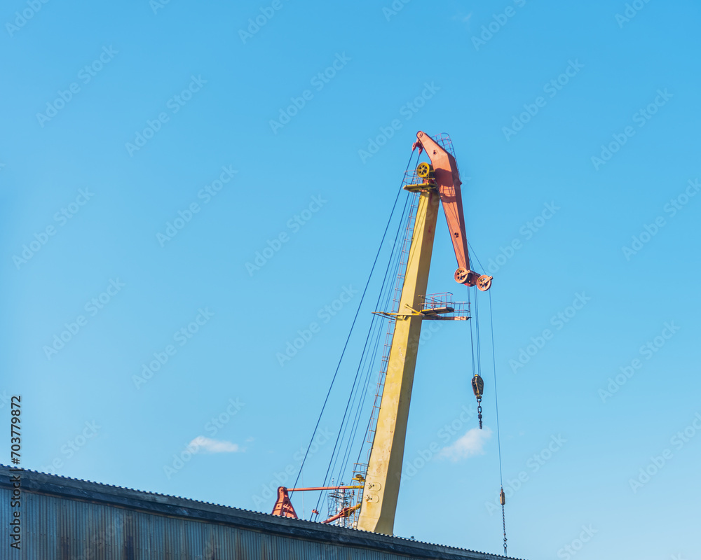boom shipbuilding cranes on a background of blue sky, natural light. boom shipbuilding cranes on a background of blue sky, natural light.