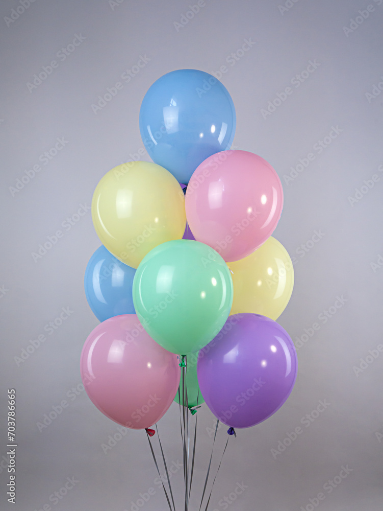 Fountain of pastel colored balloons on a gray background Fountain of pastel colored balloons on a gray background