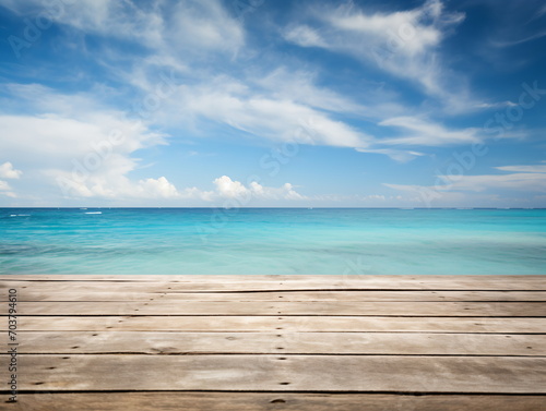 Wooden dock over calm ocean with bright blue sky and white clouds