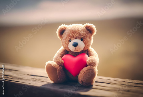 A plush teddy bear holding a red heart, with a soft-focus background, conveying warmth and affection. Ideal for Valentine's Day themes.