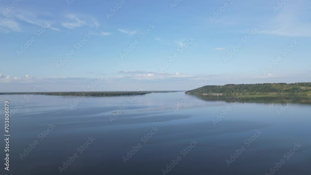View of the river from above. There is a strip of land on the horizon. View of the river from above. There is a strip of land on the horizon.