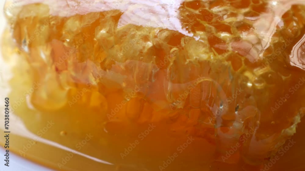 Many yellow honeycombs with flowing honey close up Many yellow honeycombs with flowing honey close up