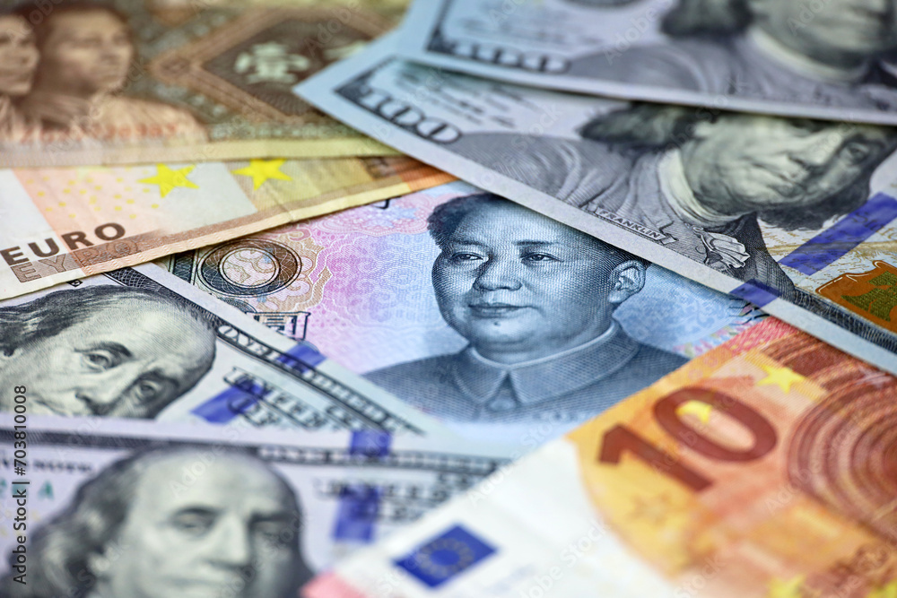 US dollars, Chinese yuan and Euro banknotes. Concept of trade war between the China and USA, american and european economy US dollars, Chinese yuan and Euro banknotes. Concept of trade war between the China and USA, american and european economy