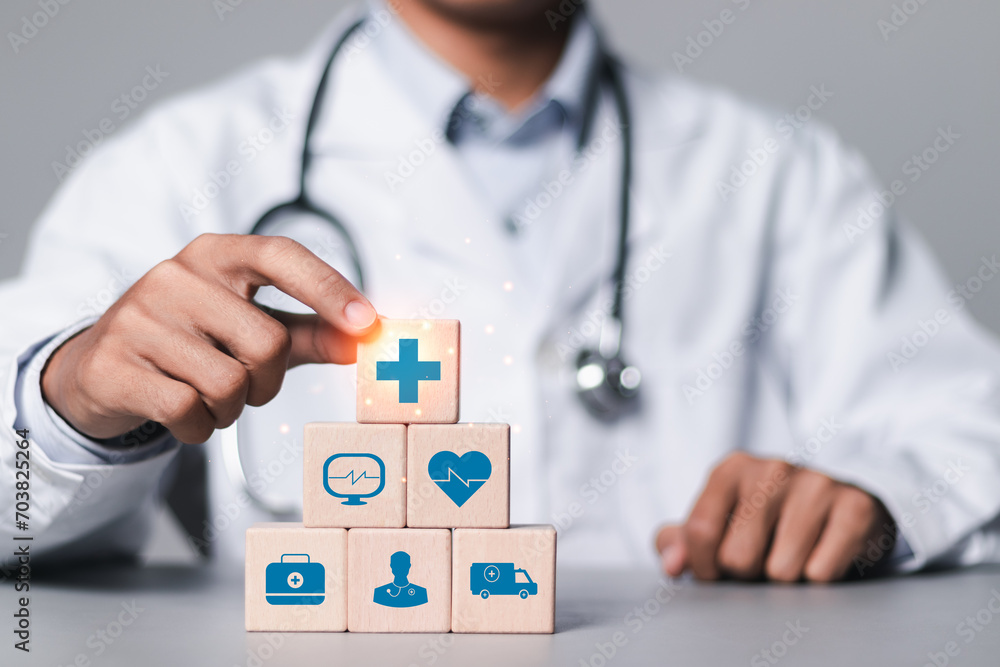 Health insurance concept, Doctor stacking wooden cubes with medical icons for healthcare and medical. health and access to welfare health.