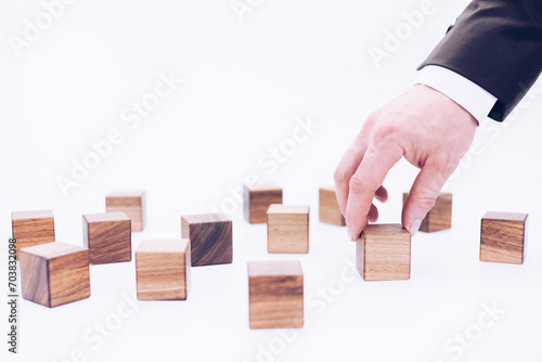 Wooden cubes and hand. The concept of people and personnel management. Manager and leader. Director and boss.