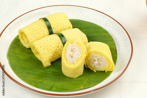 Fototapeta Naklejka Na Ścianę i Meble -  Semar Mendem, , is a Javanese traditional snack made of glutinous rice, filled with shredded chicken, wrapped in crepes.