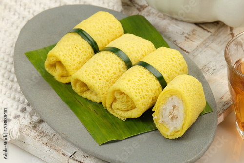 Semar Mendem, is a Javanese traditional snack made of glutinous rice, filled with shredded chicken, wrapped in crepes. photo