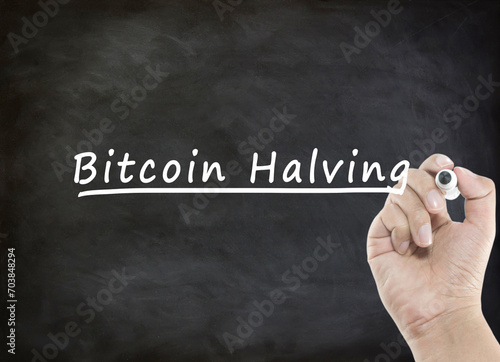 Bitcoin Halving concept with handwriting on blackboard