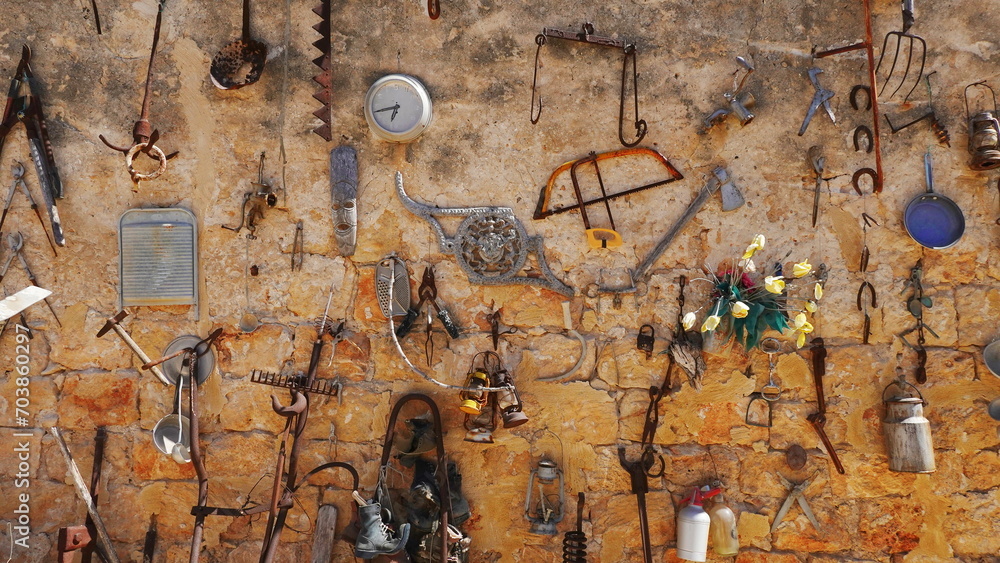 Old rusty utensils decorate the wall. Vintage Wallpaper