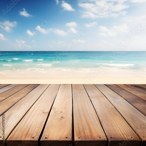 An empty wooden dock overlooking a beach with the ocean in the background,