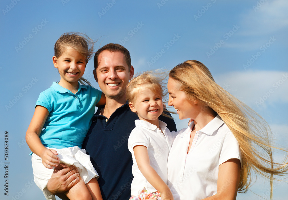 Happy young family with two children outdoors Happy young family with two children outdoors