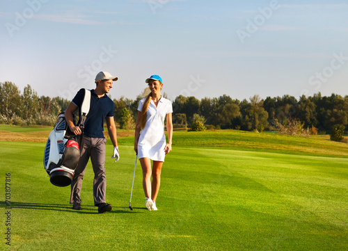 Young sportive couple playing golf