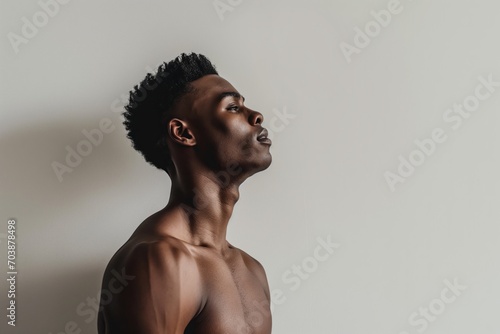 Profile photo of young hadsome African American man against grey background with space for text photo